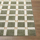 Close up of Kalkin Olive Area Rug featuring a green and white grid pattern on a wood floor. Front