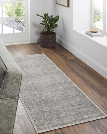 Entryway with gray sofa and Amasai Area Rug in gray, pink, and sage on wood floor near white door and window. Roomscene-Runner