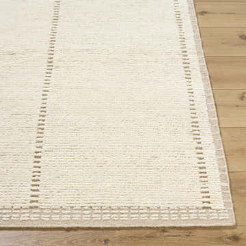 Close up of the hand knotted Kimani Area Rug. Ivory wool rug with sandstone accents and a geometric border. Front