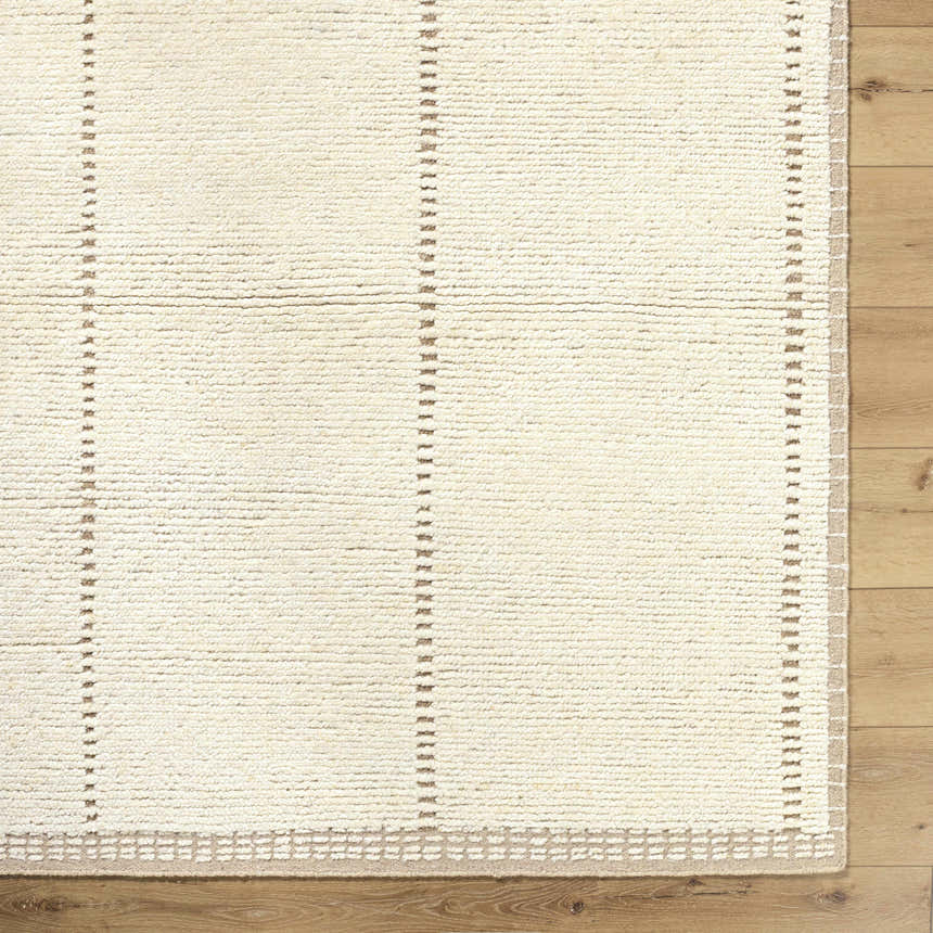Close up of the hand knotted Kimani Area Rug showing the ivory wool texture and sandstone stripe pattern. Corner