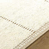 Close-up of the hand-knotted Kimani Area Rug; ivory and sandstone wool with a subtle, textured farmhouse design. Texture