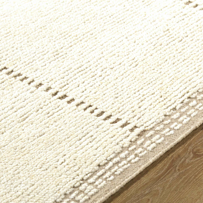 Close-up of the hand-knotted Kimani Area Rug; ivory and sandstone wool with a subtle, textured farmhouse design. Texture