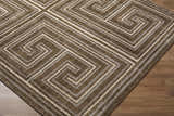 Close-up of the Kekapa Area Rug, showcasing its brown, beige, and white geometric maze pattern and machine-woven texture. Corner