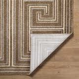Close-up of the Kekapa Area Rug showing its brown, beige, and white geometric pattern and machine-woven texture. Fold