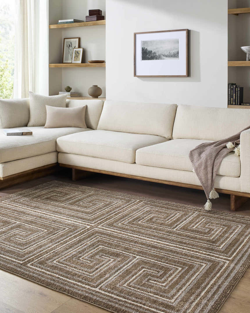 Living room scene with a neutral sectional sofa and the brown geometric Kekapa Area Rug. Roomscene-Rectangle