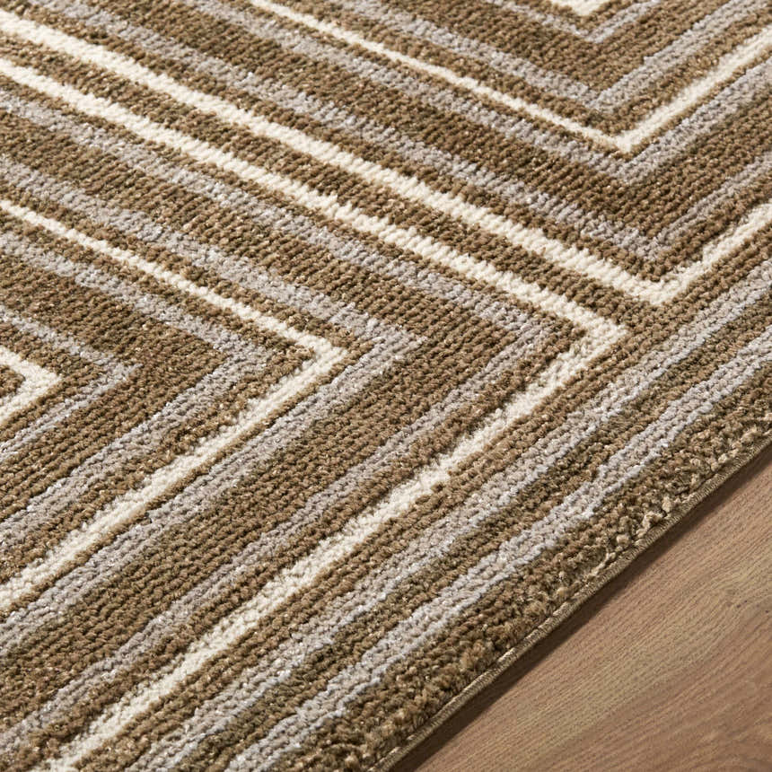 Close-up of the Kekapa Area Rug showing its brown, tan, and cream chevron pattern and textured, machine-woven construction. Texture