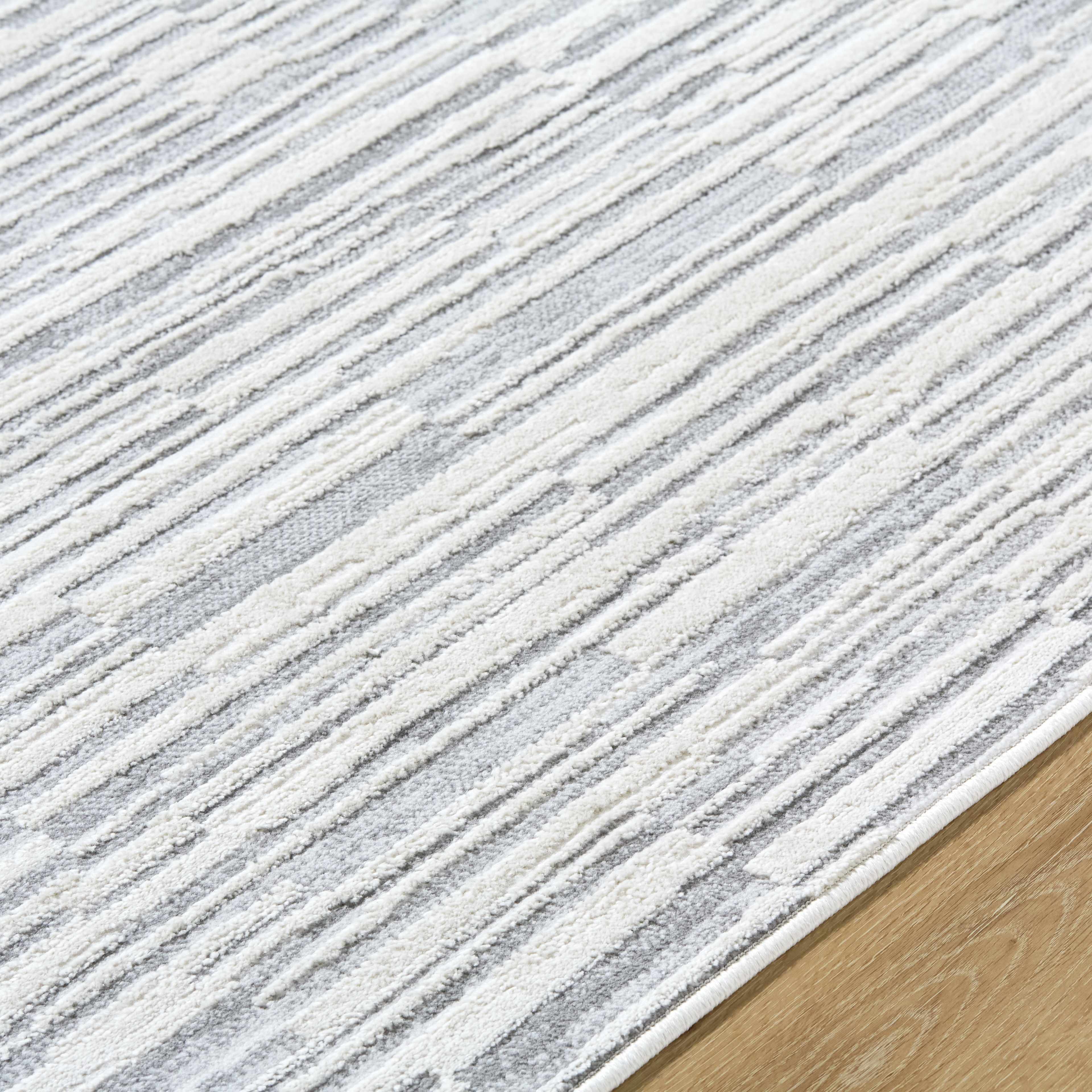 Close-up of the texture on Alexey Gray Broken-Striped Area Rug, showing fabric weave and feel. Contemporary Area Rug Backing  5'3" x 7' Rectangle7'10" x 10' Rectangle