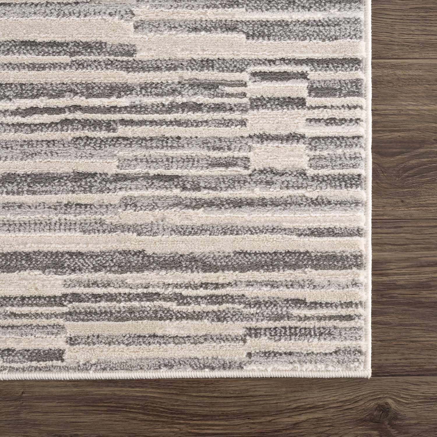 Zoomed-in view of the edge of Alexey Gray Broken-Striped Area Rug, focusing on border details and craftsmanship. Contemporary Area Rug Backing  