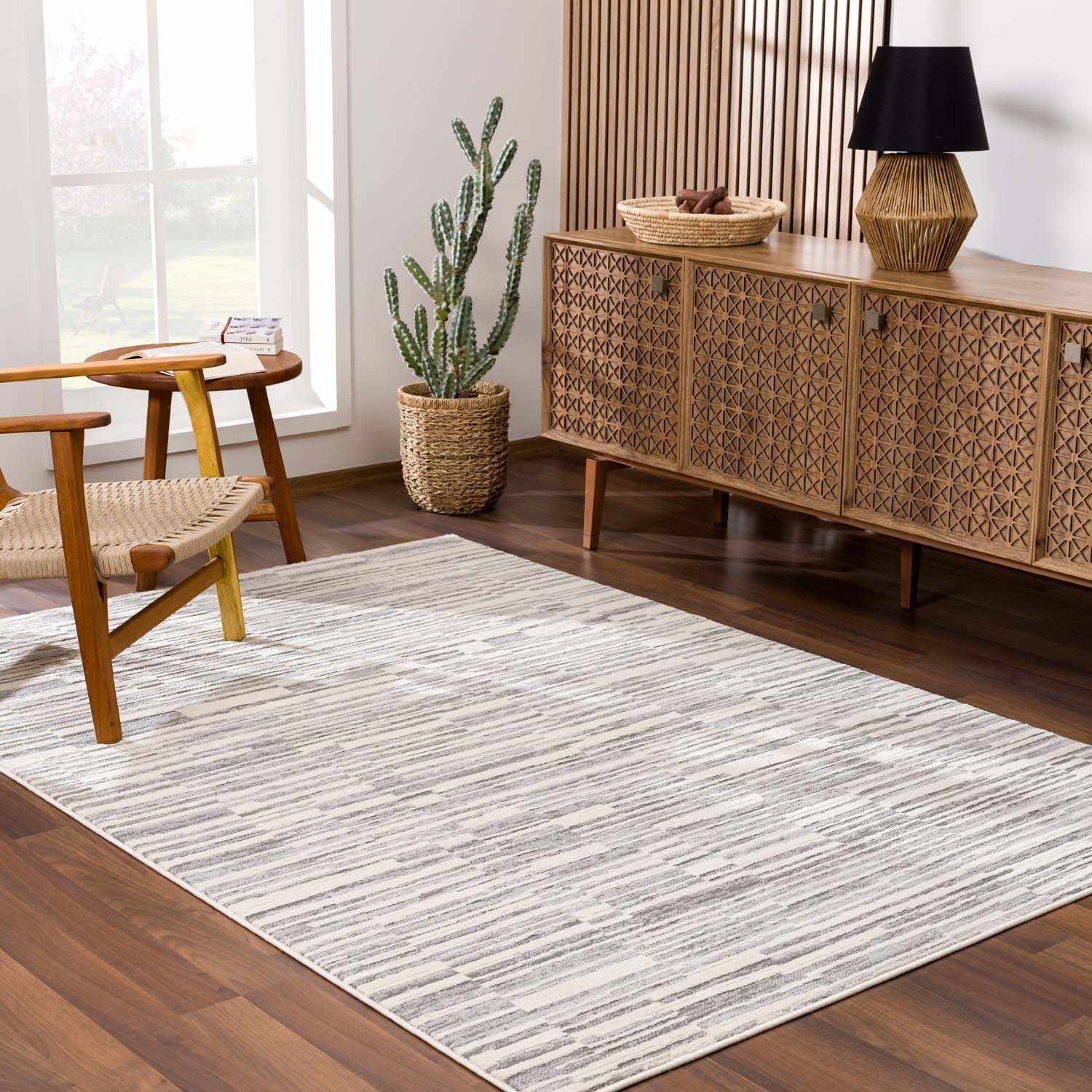 Alexey Gray Broken-Striped Area Rug placed in a styled room setting, harmonizing with surrounding room decor. Contemporary Area Rug Backing  