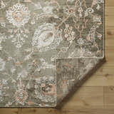 Close up of the Limay Premium Wool Rug showing its taupe, beige, and coral floral pattern. Fold