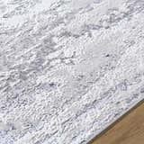 Close-up of the Arenda Light Gray Area Rug showing its contemporary cream and gray pattern and soft texture. Texture