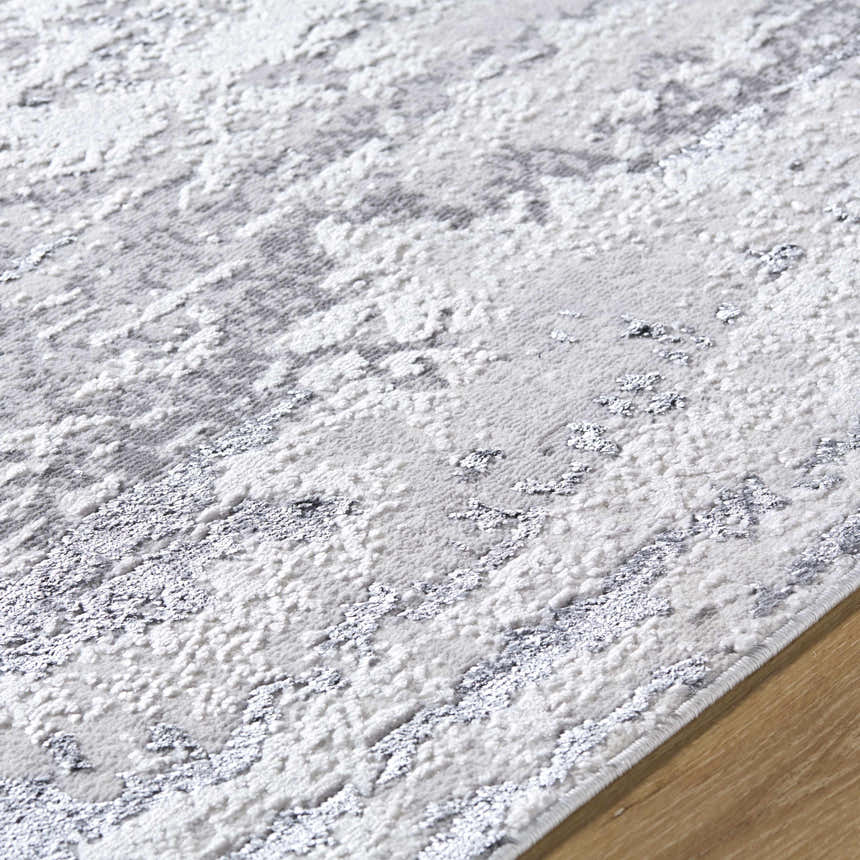 Close-up of the Arenda Light Gray Area Rug showing its contemporary cream and gray pattern and soft texture. Texture