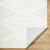 Close-up of the Annika Beige 3D Washable Area Rug showing its geometric pattern and textured design on wood floor. Fold