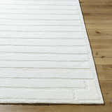 Close up of the Aurex Cream Stepped Arch Art Deco Wool Rug showing texture and pattern on wood flooring. Front