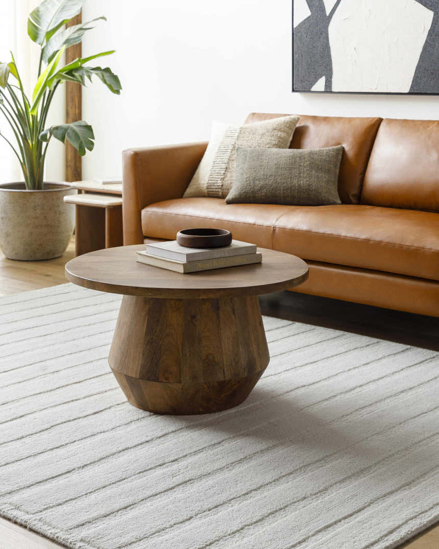 Living room scene with brown leather sofa and Aurex Cream Stepped Arch Art Deco Wool Rug. Roomscene-Rectangle
