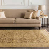 Living room scene with a tan sofa and a tan, floral Lochmaben Premium Wool Rug. Roomscene-Rectangle