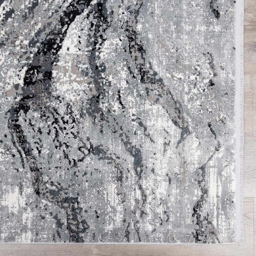 Close-up of the Littleport Luxury Fringed Faux Silk Rug. Abstract design in black, charcoal, gray, and light gray tones. Swatch
