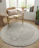 Cozy reading nook with Alinae Area Rug in light sage and cream, chair, and natural light. Roomscene-Round