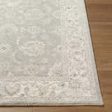 Close up of the Alinae Area Rug showing its traditional floral pattern, cream, green, and slate blue colors. Front