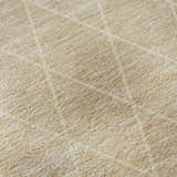 Close-up of the beige and salmon Dalyn Luxury Lazio rug, showing its subtle geometric pattern and textured weave.