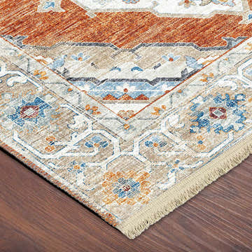Close-up of Dalyn Marbella Spice rug showing traditional floral pattern in chestnut, ivory, blue, and paprika.