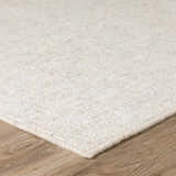 Close up of the ivory Dalyn Mateo Area Rug showing texture and detail on wood floor.