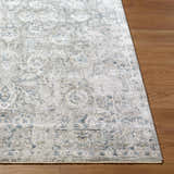 Close-up of the Melianna Gray Blue rug showing its traditional pattern, texture, and colors on a wood floor. Front