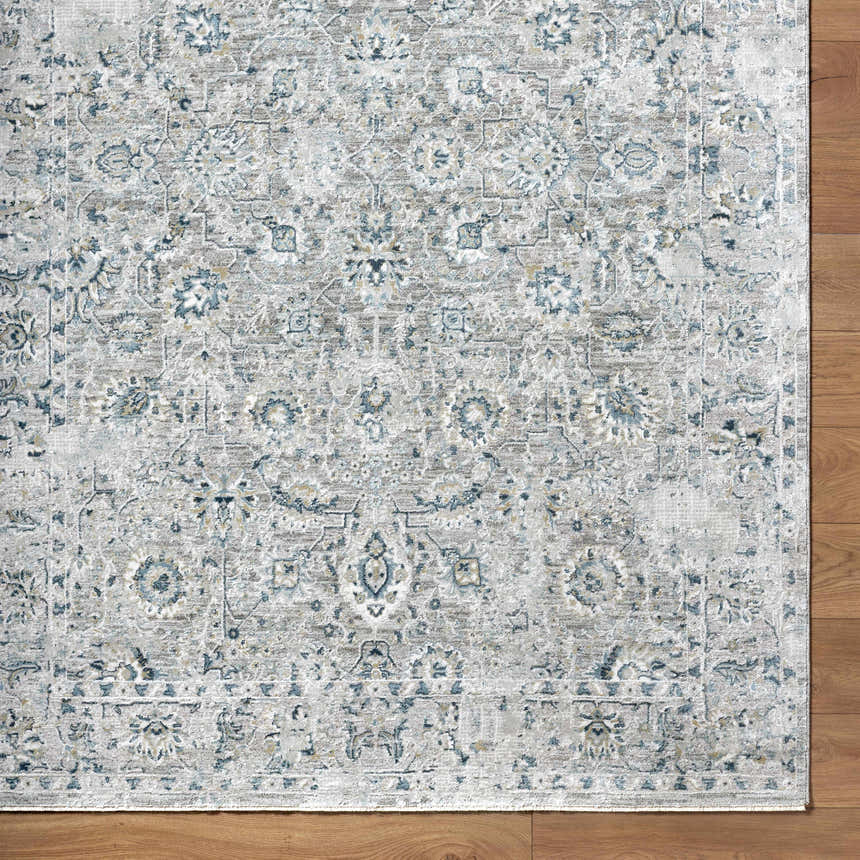 Close-up of the Melianna Gray Blue rug showing its traditional floral pattern and luxe texture on hardwood floor. Corner