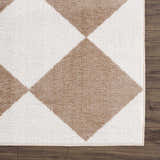 Close-up of the Ulric Brown Diamond Washable Area Rug showing its geometric diamond pattern and soft texture. Brown and off-white colors. Swatch