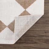Close-up of the Ulric Brown Diamond Washable Area Rug showing its geometric diamond pattern, brown and cream colors, and woven texture. Fold