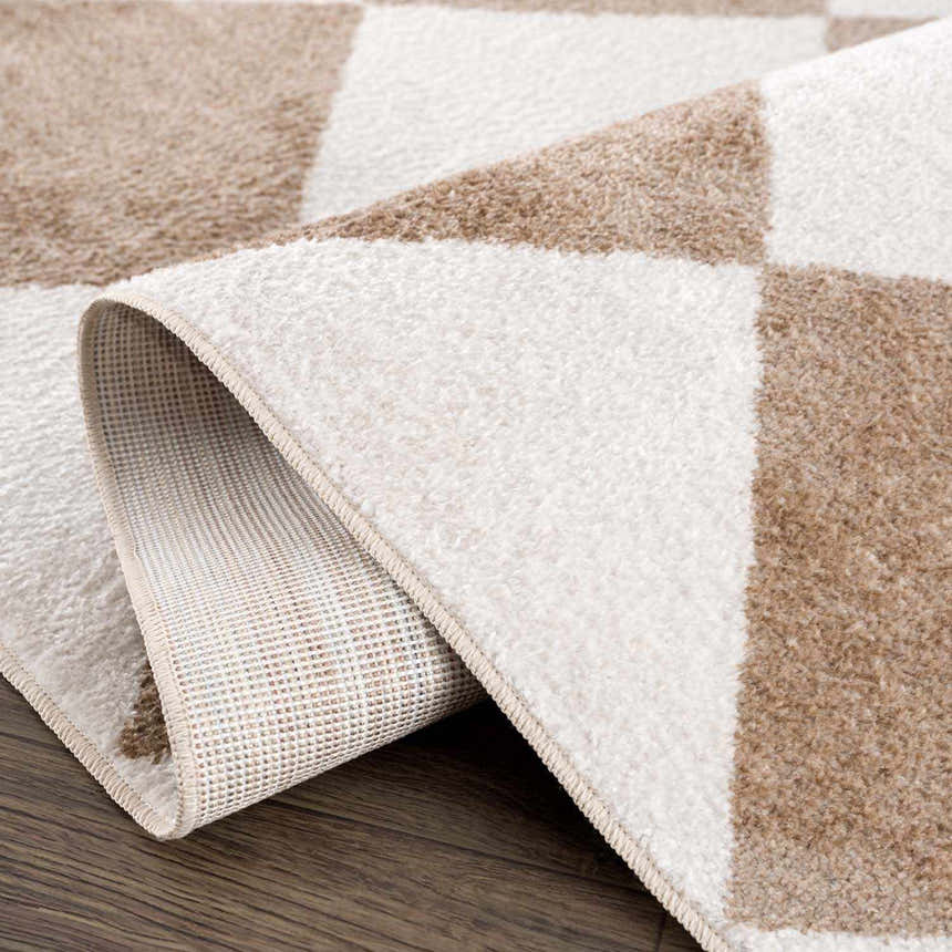 Close-up of the Ulric Brown Diamond Washable Area Rug showcasing its geometric pattern, soft texture, and durable backing. Fold