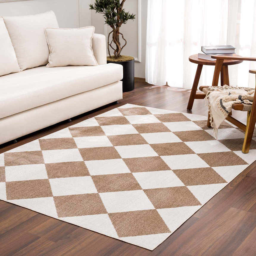 Living room scene with cream sofa and the Ulric Brown Diamond Washable Area Rug featuring a brown and cream geometric pattern. Roomscene-Rectangle
