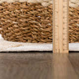 Close-up of the Ulric Light Brown Diamond Washable Area Rug showing texture and pile height with a ruler and basket. Pile