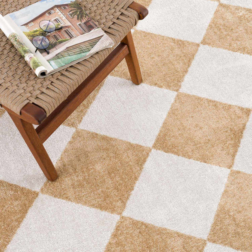 Close-up of the Ulric Light Brown Diamond Washable Area Rug featuring a cream and light brown checkerboard pattern. Styleshot