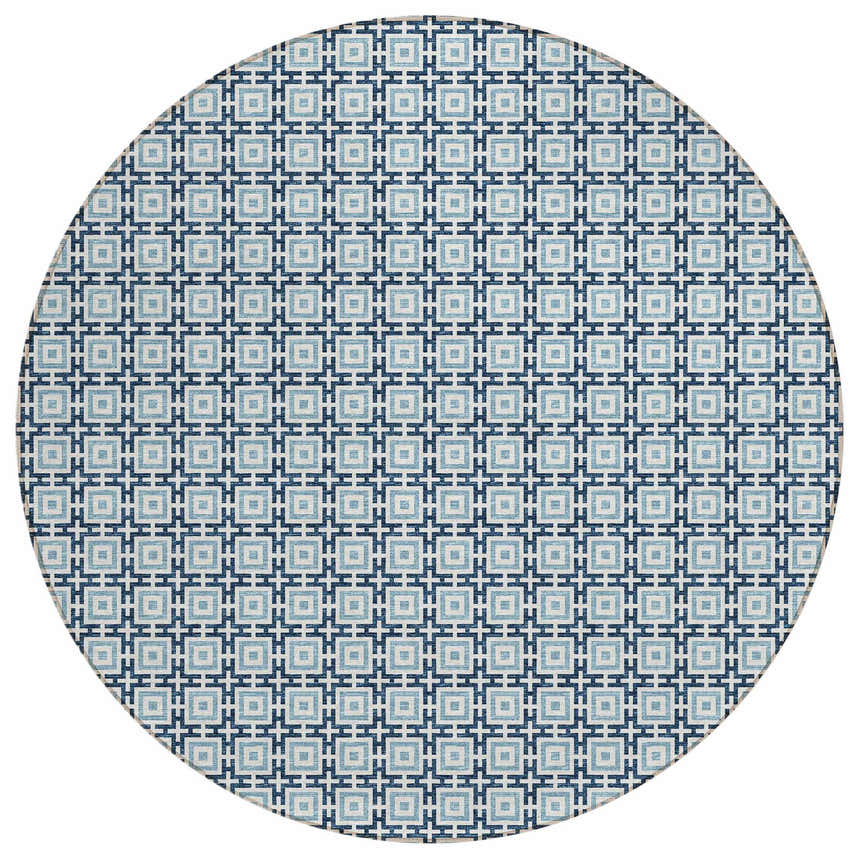 Close-up of a round Dalyn Marlo MO1 Navy Washable Area Rug. Features a geometric pattern in navy, light blue, and white.