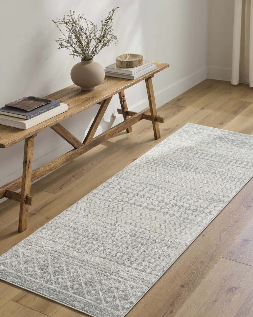 Entryway with light wood floors and Morey Area Rug runner in light gray, styled with a rustic wood bench. Roomscene-Runner