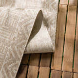 Close-up of the Epson Dark Beige Indoor & Outdoor Area Rug showing its beige color and woven texture on a wood deck. Fold