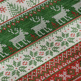 Close up of the Dalyn Luxury Merry & Bright rug. Red, green, and white holiday pattern with reindeer and trees.