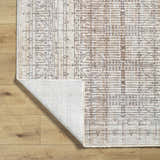 Close up of Usonia Machine Woven USO-2304 rug. Dark red, gray, and white geometric pattern on a polyester rug with a folded corner. Fold