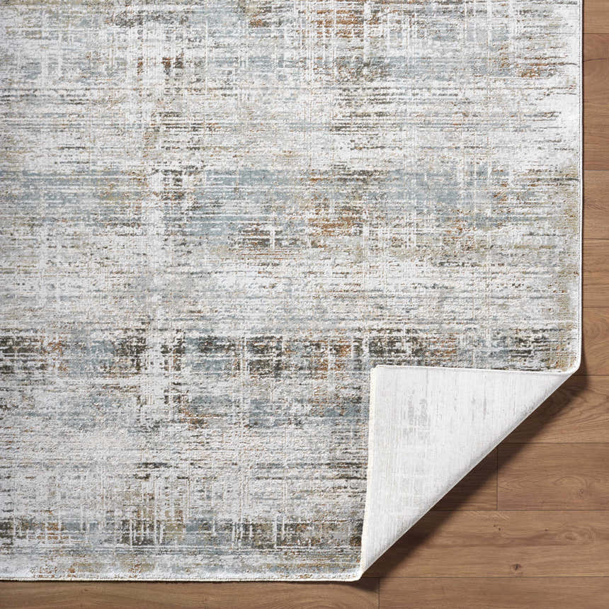 Close-up of the Neron Blue Gray Thick Luxe Abstract Rug showing charcoal, cream, and brown tones. Southwestern style. Fold