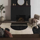 Living room with a black fireplace and the Brooklyn Modern hand tufted wool area rug in cream and black geometric design. Roomscene-Rectangle