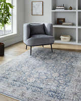 Living room scene with gray chair on a beige and blue traditional Nnena Area Rug. Roomscene-Rectangle