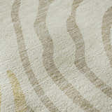 Close-up of the Dalyn Neo NO10 Gold Washable Area Rug, featuring beige and gold wavy stripes on a soft, textured surface.