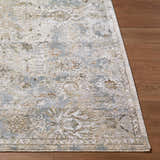 Close-up of the Nasir Thick Luxe Boutique Rug showing its floral pattern, cream, light brown, and light gray colors. Front