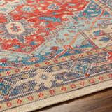 Close-up of the Oracabessa Premium Area Rug. Hand-knotted wool rug with blue, red, and beige Persian-style design. Texture