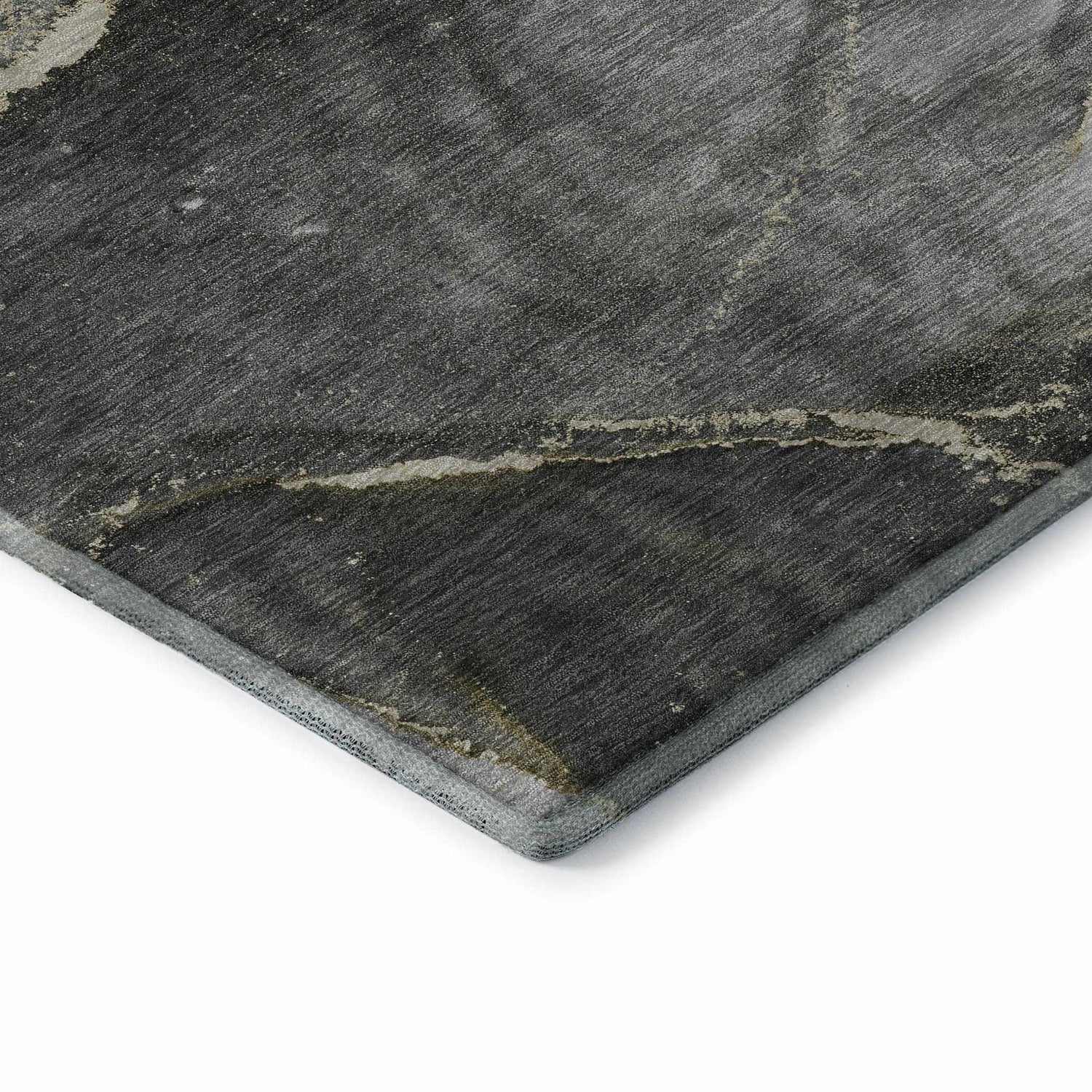 Close-up of the Dalyn Luxury Odyssey OY14 Charcoal Washable Area Rug showing texture and colors: black, gray, taupe, gold.