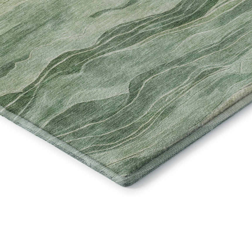 Close-up of the Dalyn Pacifica PA6 Green Washable Area Rug, showing its aloe, gold, and olive abstract pattern and soft texture.