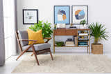 Living room scene with a modern chair and the Pawhuska Area Rug in charcoal and peach. Roomscene-Rectangle