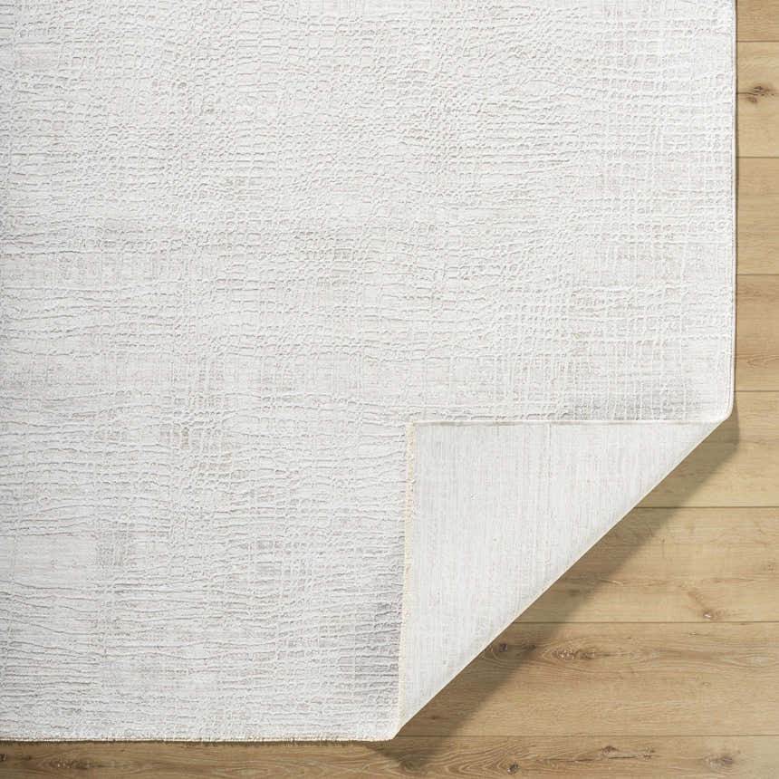 Close-up of the Axelia Charcoal Area Rug showing its cream and charcoal textured Southwestern-style design. Fold