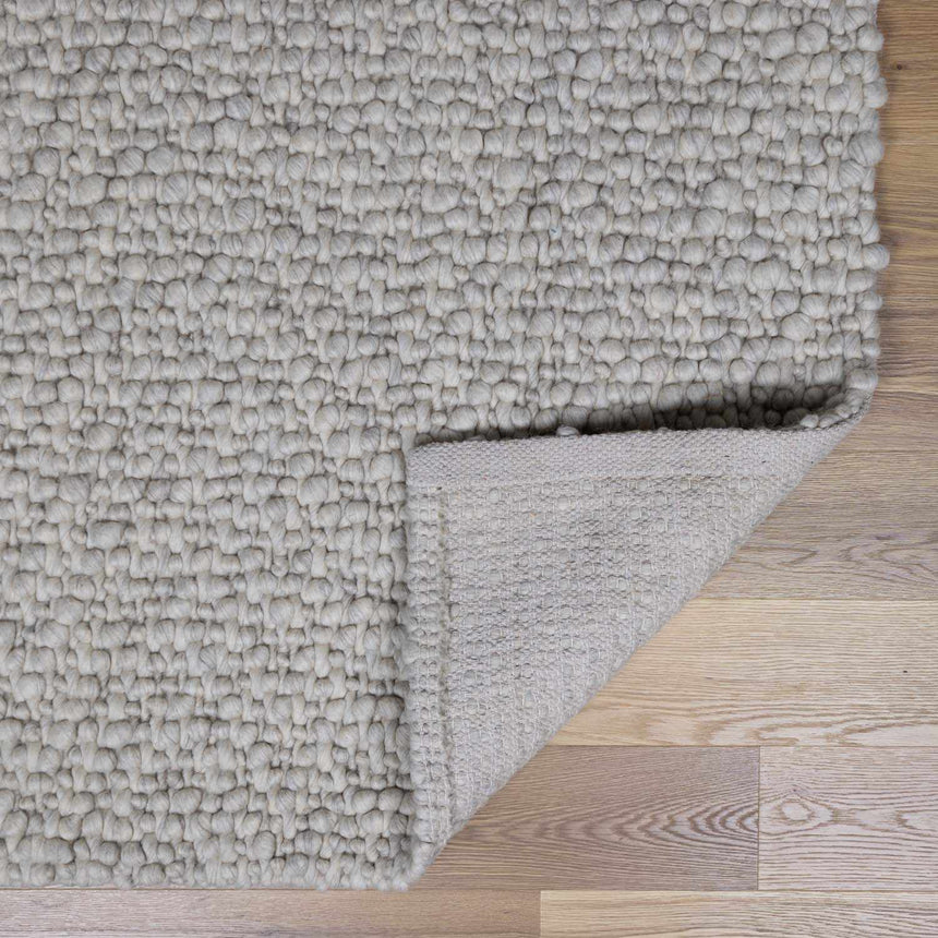 Penmaen Solid Cream Hand-Woven Wool Rug